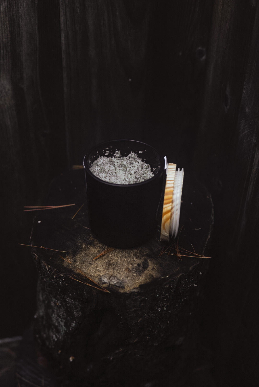 Kelp-infused sea salt body scrub with lemongrass scent. Natural exfoliant and moisturizer from Maine Seaweed Company Nautical Farms. 12 oz comes in reusable black matte jar with raw wood lid.