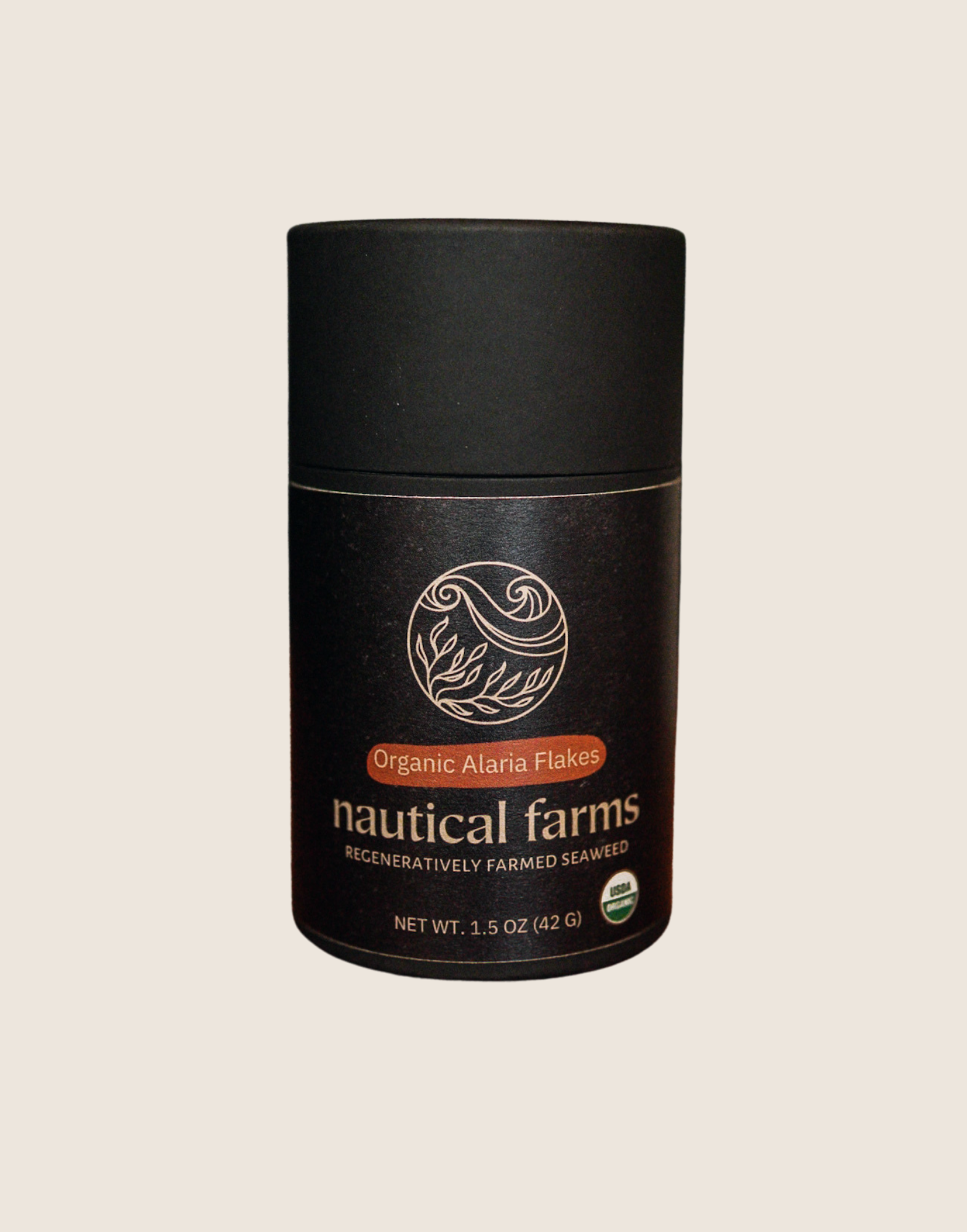 Healthy and sustainable alaria (wakame) flakes from regenerative ocean aquaculture farm in Maine. 1.5 oz of sustainable Sea Vegetables in a kraft black tube.