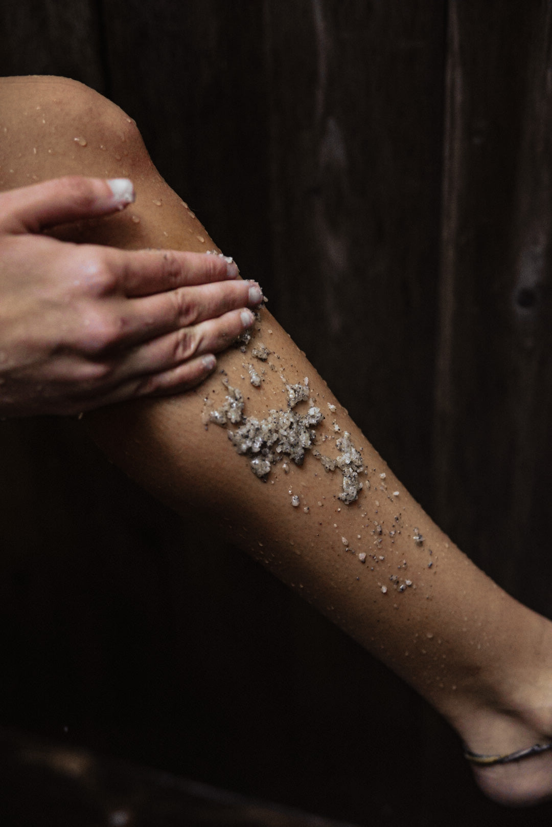 Kelp-infused sea salt body scrub with lemongrass scent. Natural exfoliant and moisturizer from Maine Seaweed Company Nautical Farms. 12 oz comes in reusable black matte jar with raw wood lid.